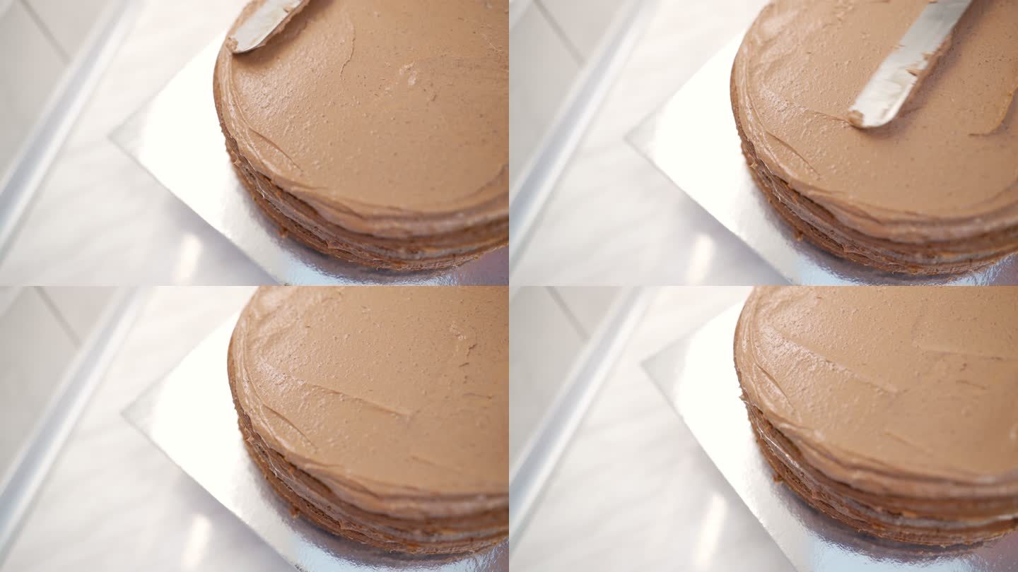 女人用巧克力奶油为蛋糕糖霜的特写镜头