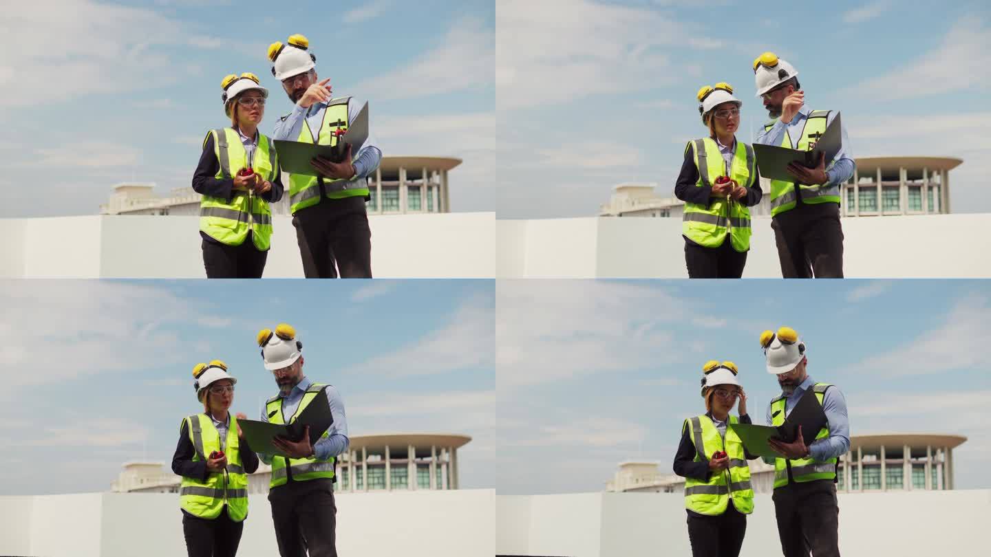 团队维护工程师男、女检查在建筑露台上的工作，维护建筑内的空调系统