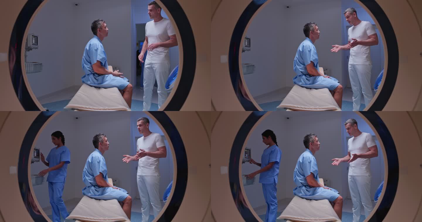 DS男放射技师进入成像室，与坐在CAT扫描仪桌上的男患者握手