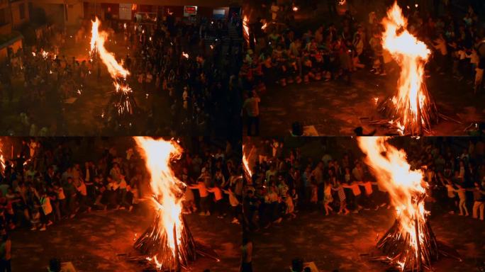民族节日楚雄彝族火把节游客围绕火堆跳舞