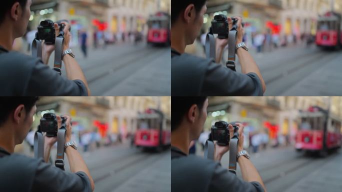 年轻的男性摄影师和摄像师旅游期间在城市拍摄照片和视频