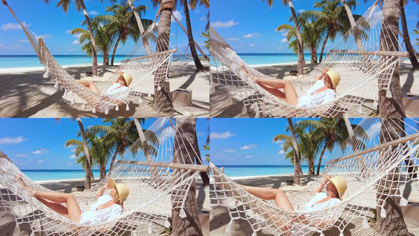 在热带岛屿度假胜地吊床上休息的女人