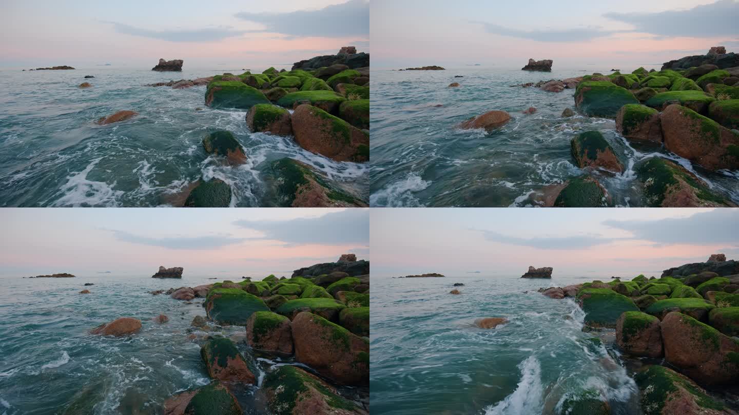 中国青岛日落时分的海边礁石