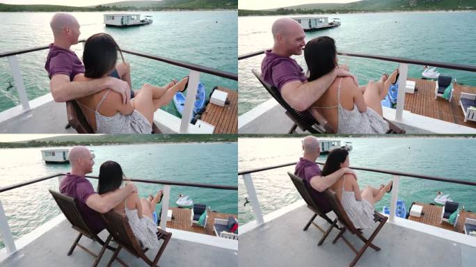 南非开普敦，一对幸福的夫妇坐在船屋甲板上