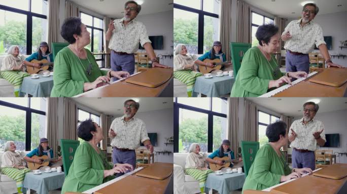 一群老年朋友喜欢在客厅里一起弹钢琴和唱歌，亚洲老年朋友在家里聚会