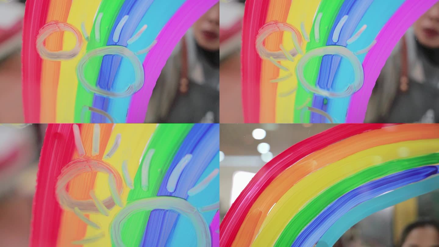 美术培训老师在透明玻璃上画彩虹