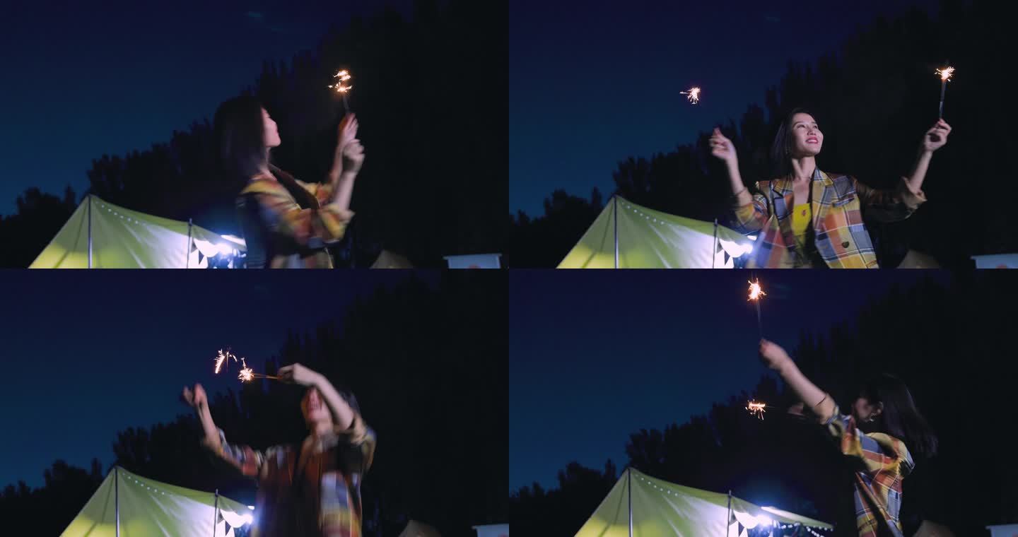 晚上一个年轻女孩在露营地放烟花
