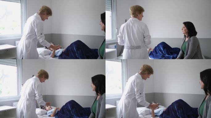 医生在多导睡眠图（睡眠研究）前与一名男孩交谈