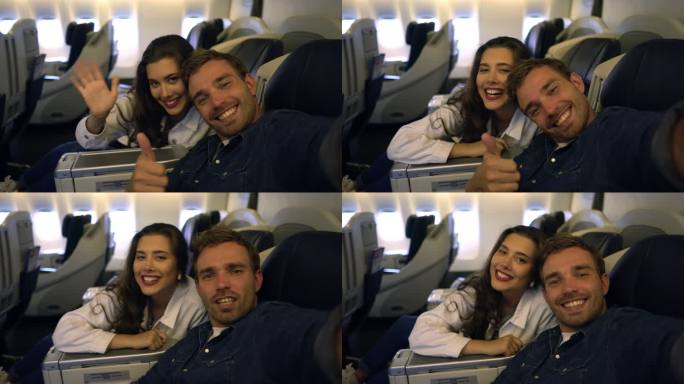 一对年轻夫妇在飞机上自拍，看起来很兴奋，并做手势和面部表情