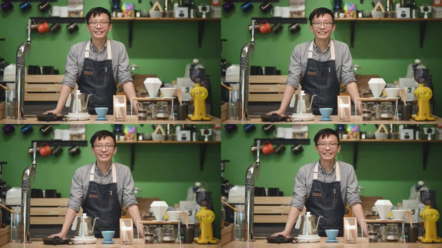 咖啡馆柜台上的亚洲中国咖啡师微笑着看着镜头