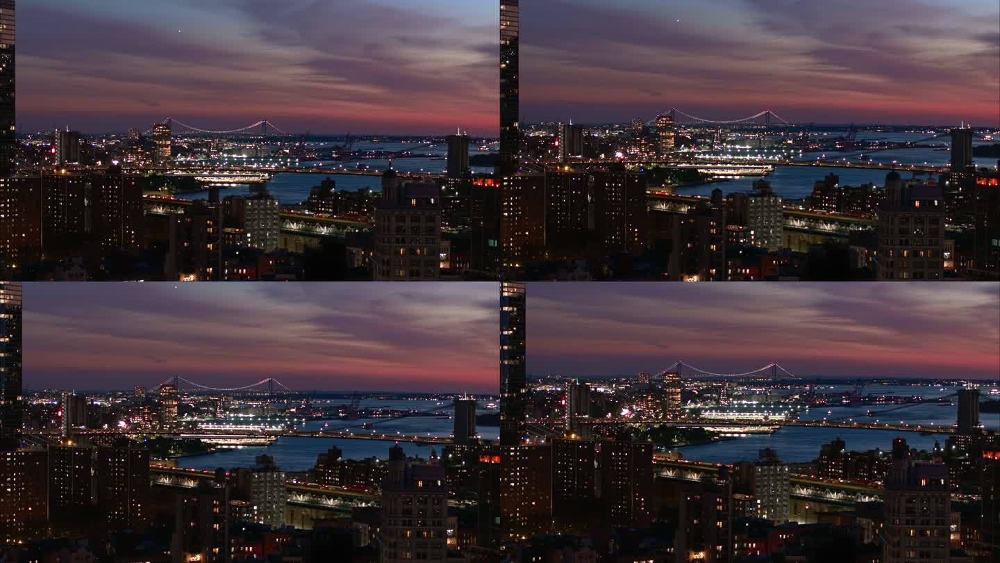 背景中的曼哈顿大桥、东河上的布鲁克林大桥和远处的维拉扎诺大桥。日落时分，纽约曼哈顿住宅区和项目的全景
