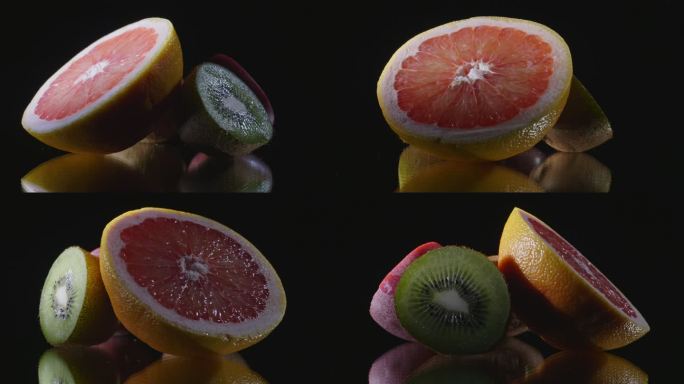 不同的水果在黑色反光表面上转动