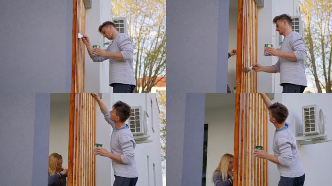 夫妇在家门口画木架