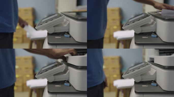 办公室工作人员使用复印机复印文件。