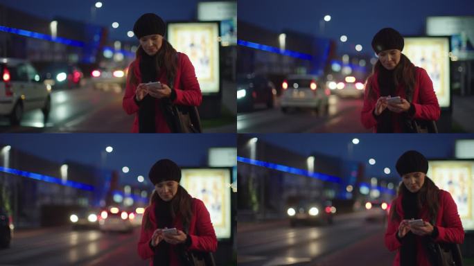 WS女人晚上在城市里使用智能手机