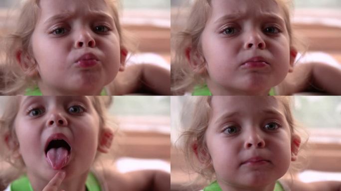 一个小女孩在镜头前皱着眉头的脸部特写