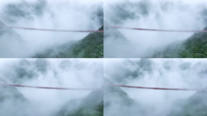 雨后云雾里桂林喀斯特山峰间横跨的铁索桥