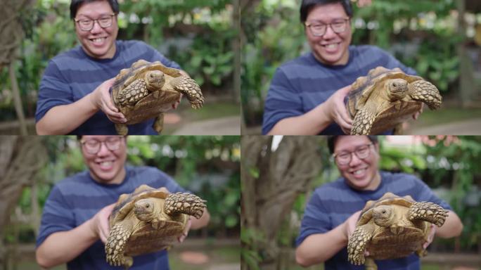 亚洲男子开心地抱着黄色沟龟