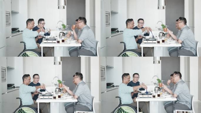 周末，一名坐轮椅的亚裔印度残疾人在公寓厨房为朋友做早餐