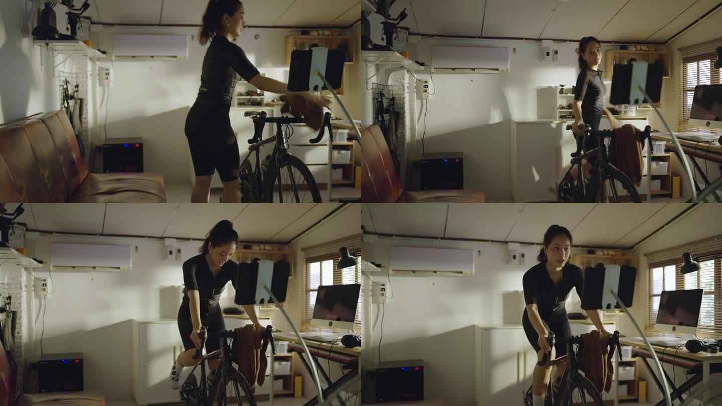 亚洲女自行车运动员，她在家锻炼。她骑自行车模拟器。