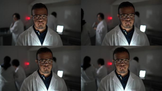 实验室里一位特殊需要的年轻科学家的肖像，背景中的同事