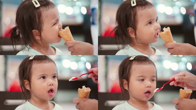 亚洲小女孩在室内餐厅吃冰淇淋