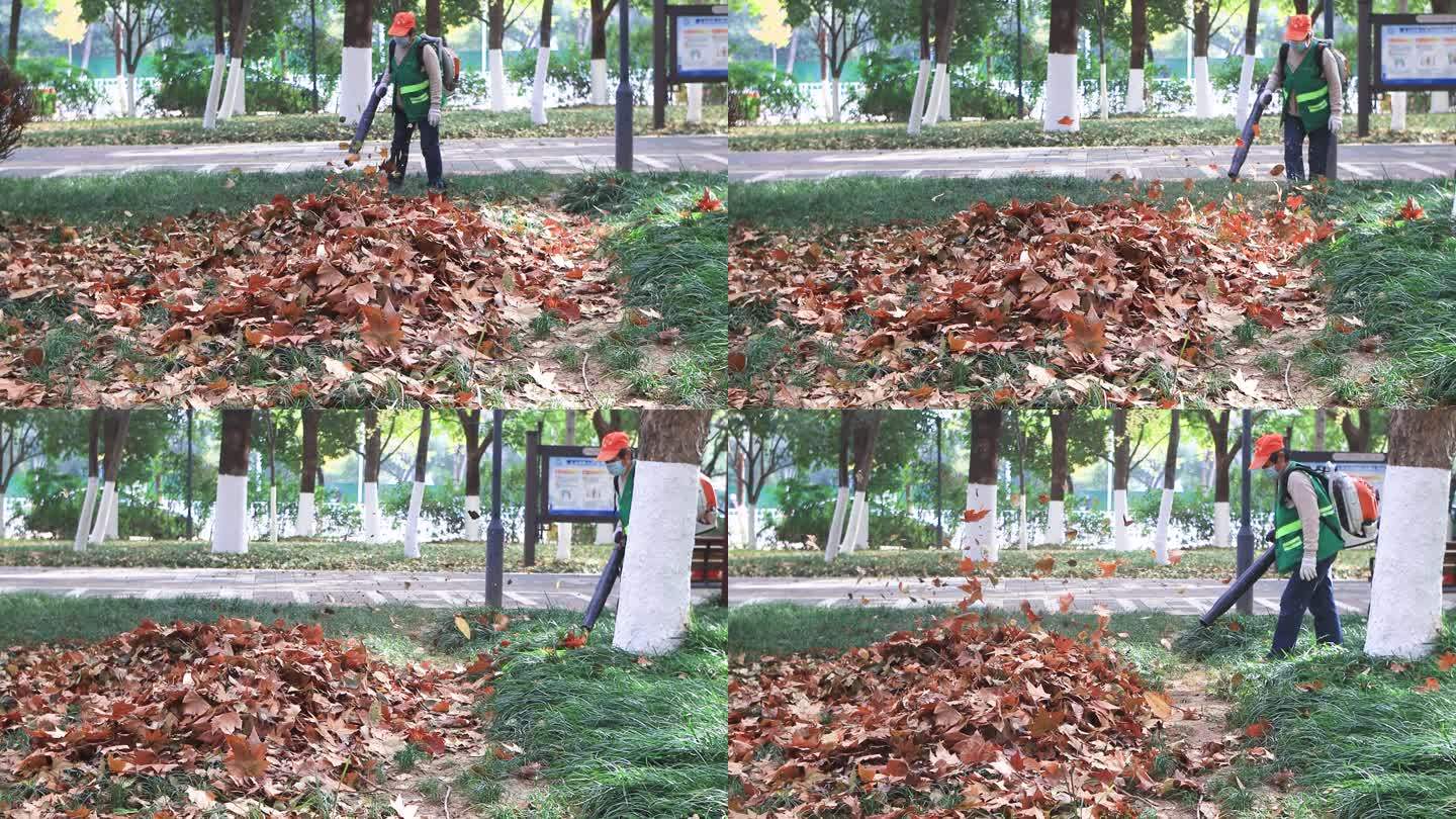 环卫工人清理公园里的落叶