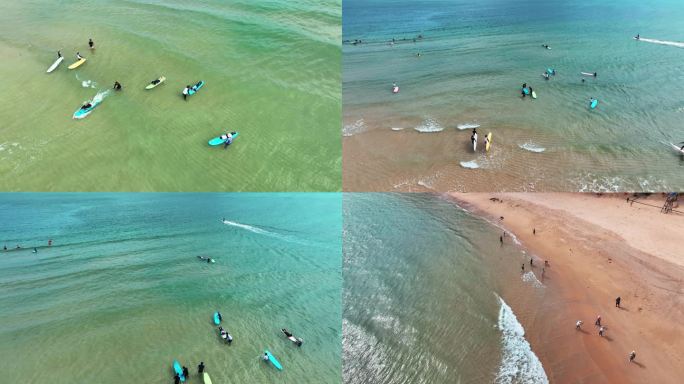 海南三亚大东海沙滩海边冲浪玩水的人群航拍
