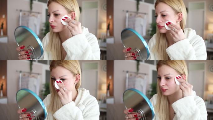 高清视频，一位迷人的年轻女子用化妆棉洗脸。