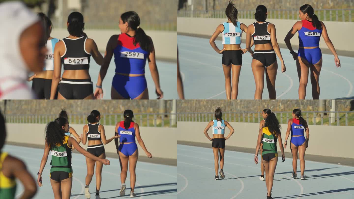 女子田径运动员在阳光充足的跑道上行走