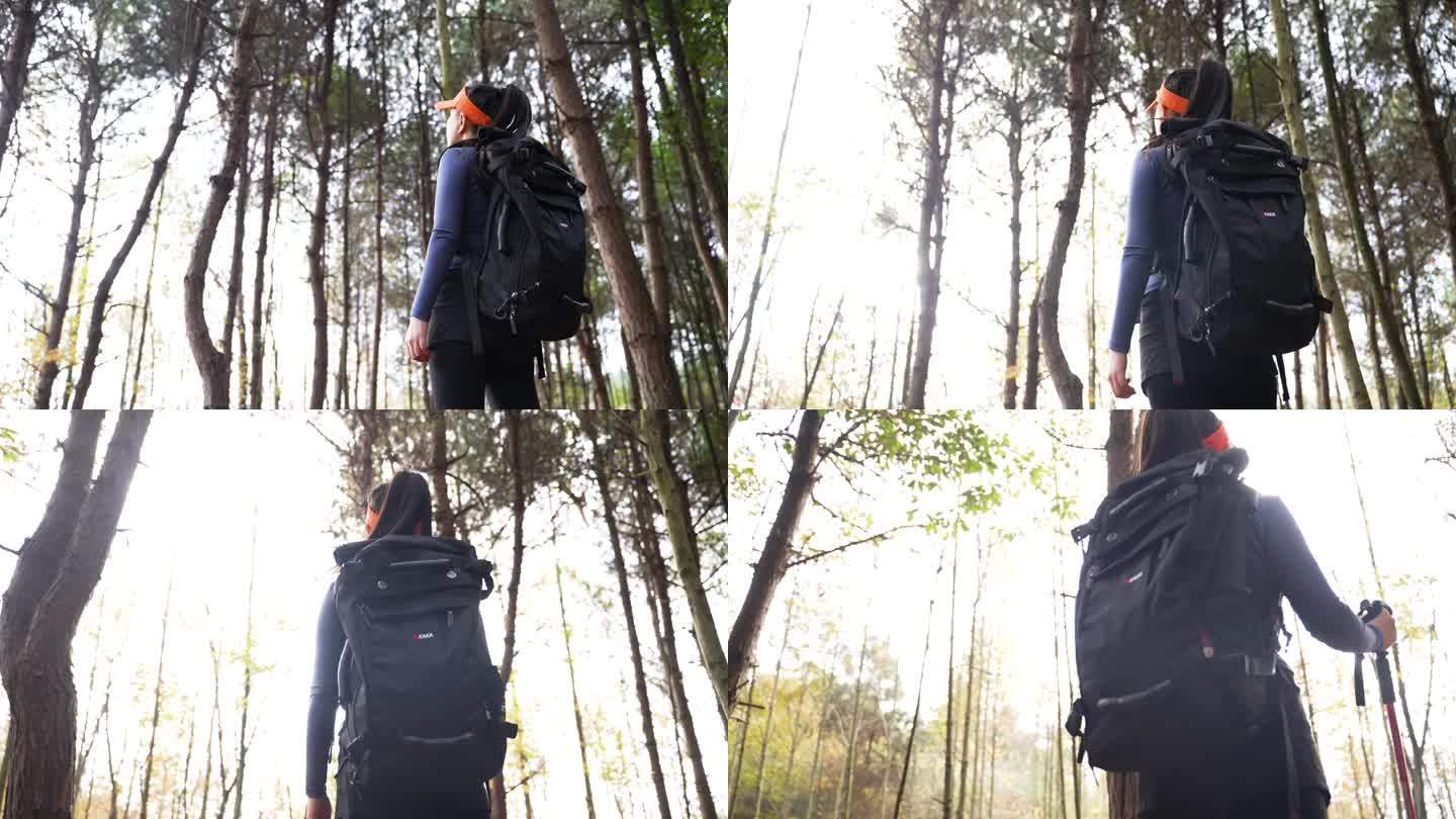 背包客女孩在林中徒步阳光天空感受自然风光