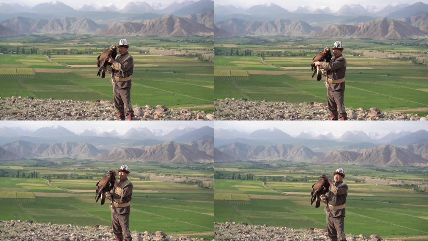 站在吉尔吉斯斯坦山脉背景上的鹰猎人