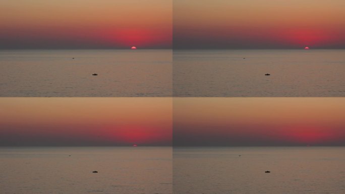 阿尔巴尼亚杜勒斯海滩的小船和海上的戏剧性日落