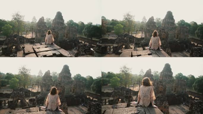 柬埔寨吴哥寺的一名妇女坐着看风景