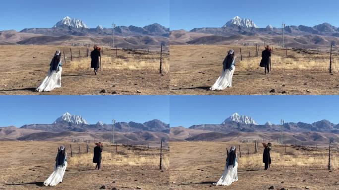 高原枯黄草原走向雪山情侣慢动作拍写真婚纱