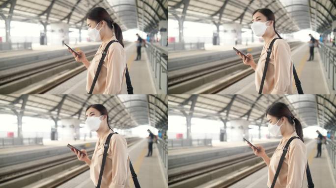 曼谷一名女子使用智能手机在车站等候火车