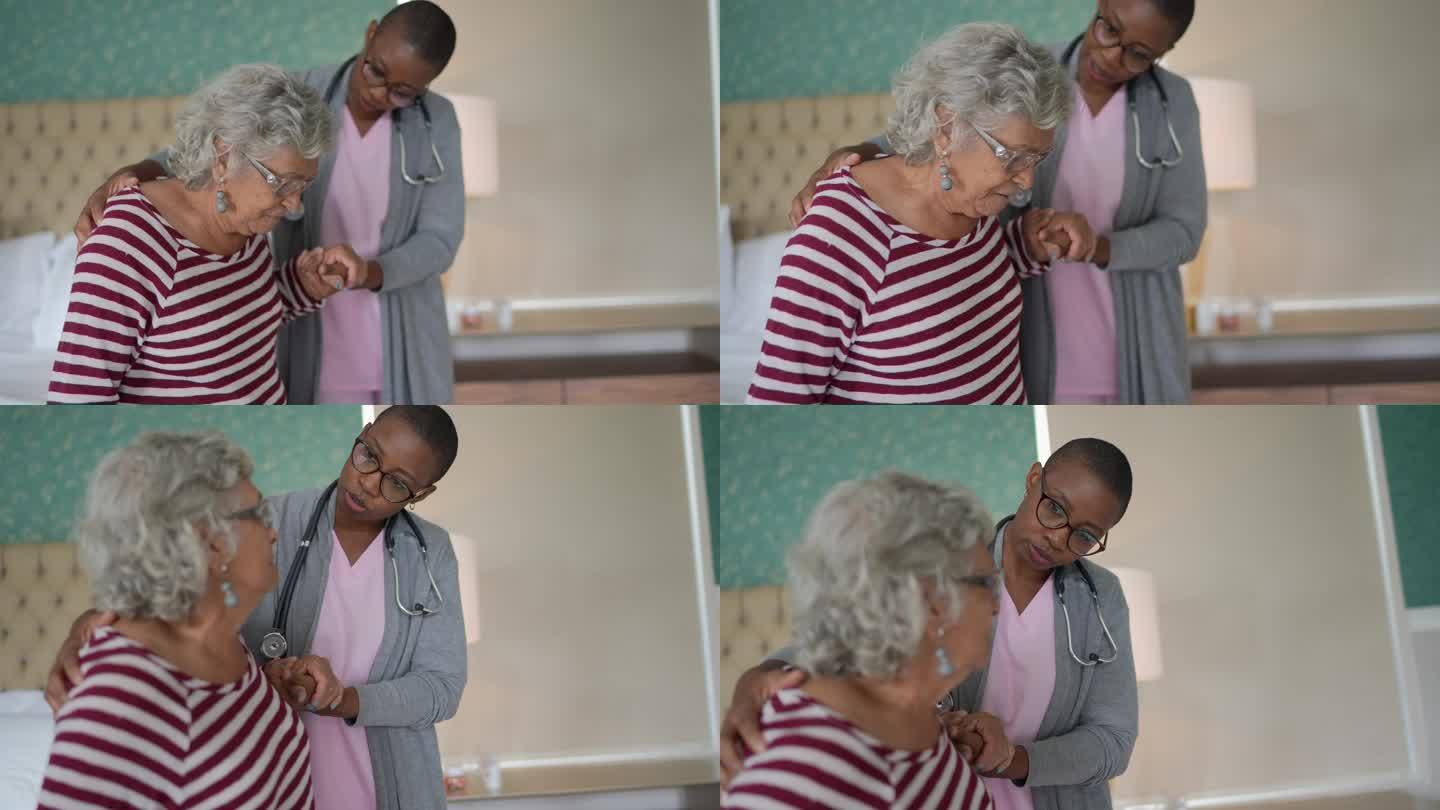 护士帮助一位站在卧室里的老年妇女