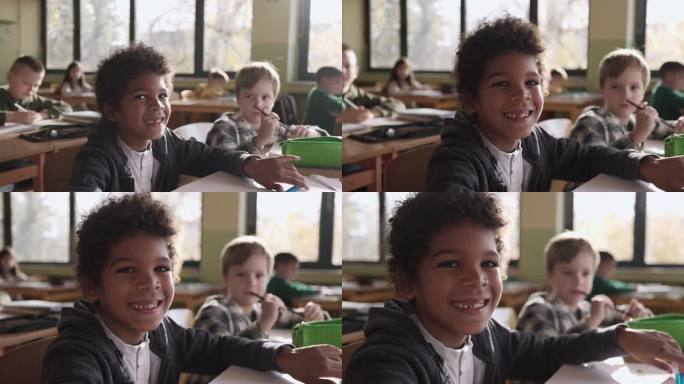 一个快乐的黑人小学生和他的朋友在学校上课。