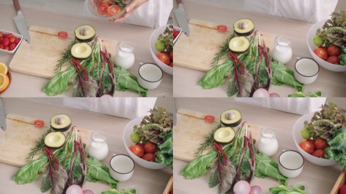 家庭厨房里的叶菜、绿橡树生菜、鳄梨、番茄、小葱，用于制作健康的食用沙拉