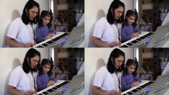 与老师一起使用钢琴键盘的女孩