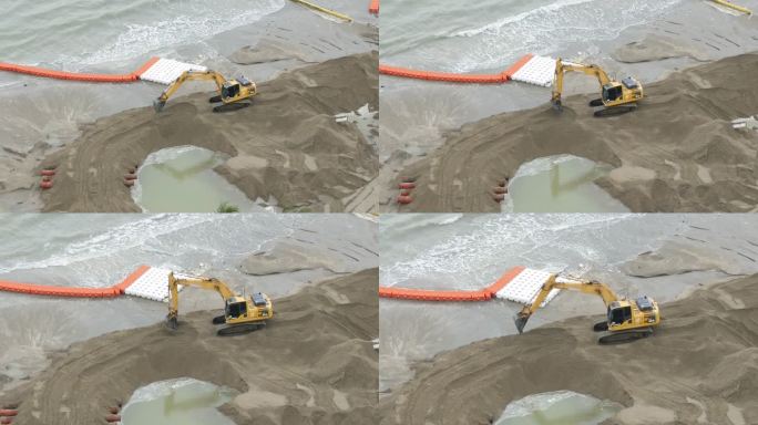 鸟瞰挖掘机正在改善海滩以保护海洋。