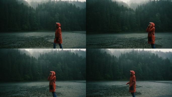雨中，穿着雨衣的女子站在湖边