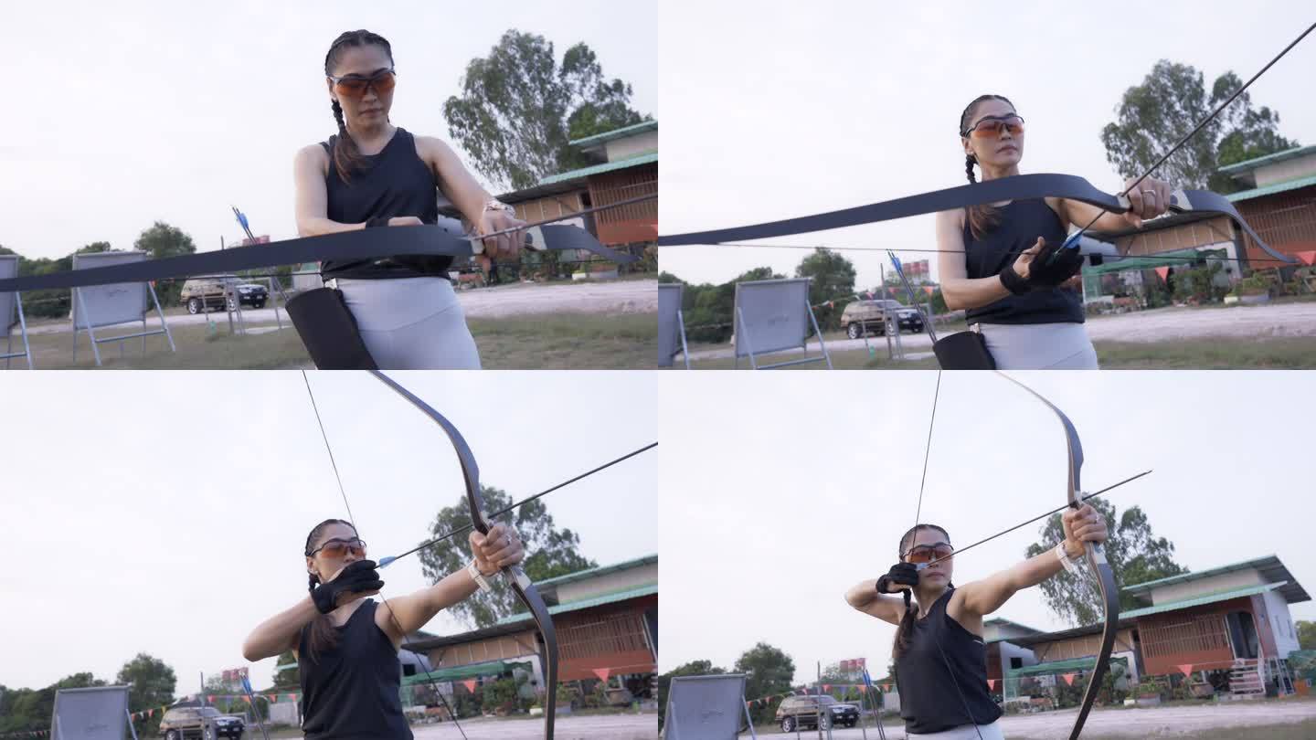 近距离观看在靶场练习射箭的迷人亚洲女性。