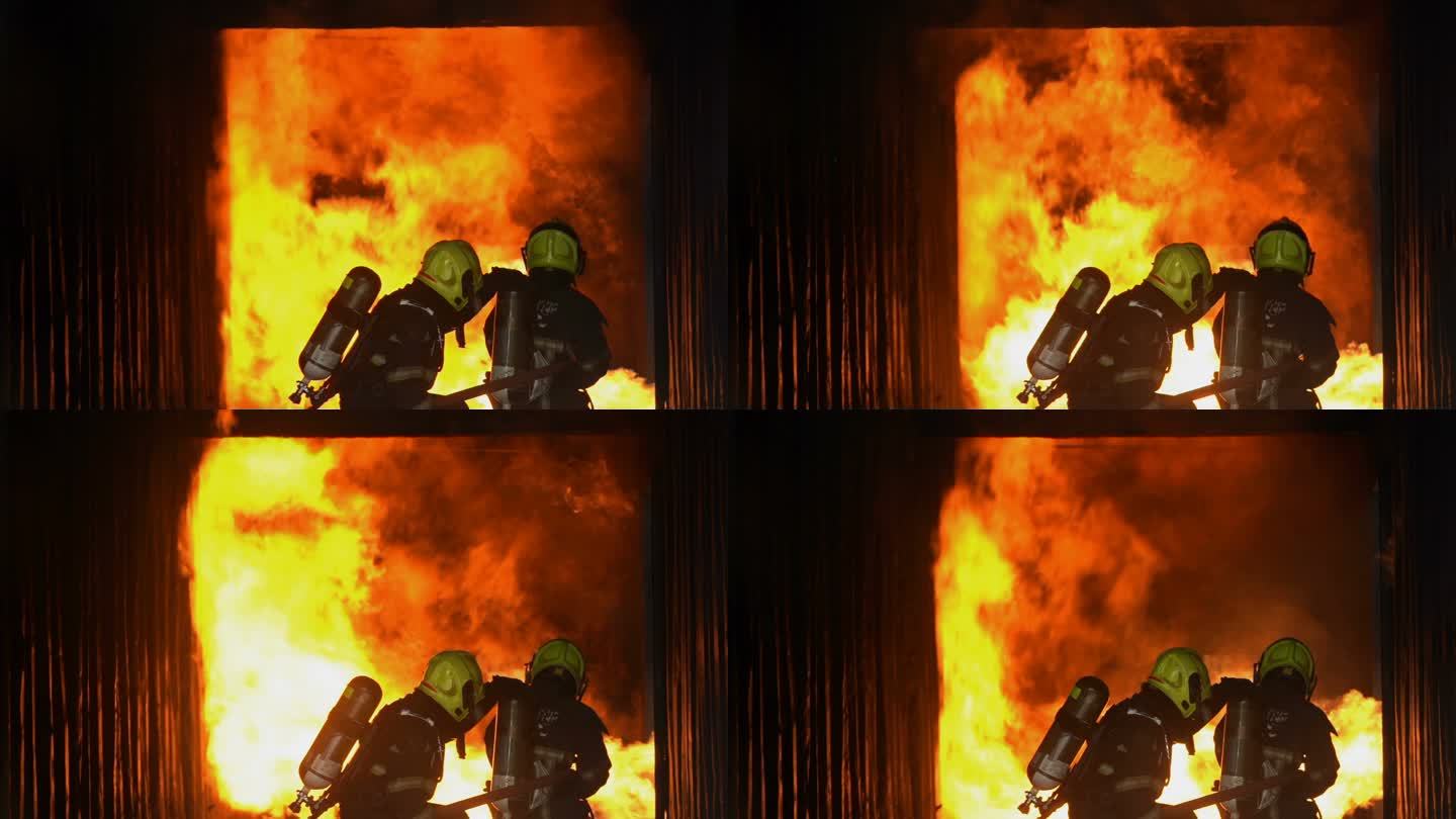 SLOW MO消防员扑灭正在燃烧的建筑火灾