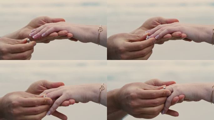 在海滩求婚时，一对面目全非的情侣。一名男子将订婚戒指放在女友手指上的特写镜头