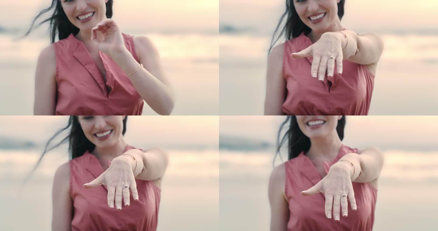 一个面目全非的快乐年轻女子在海滩上炫耀她的订婚戒指。求婚后一位面带微笑的女士展示了她的手和戒指的特写