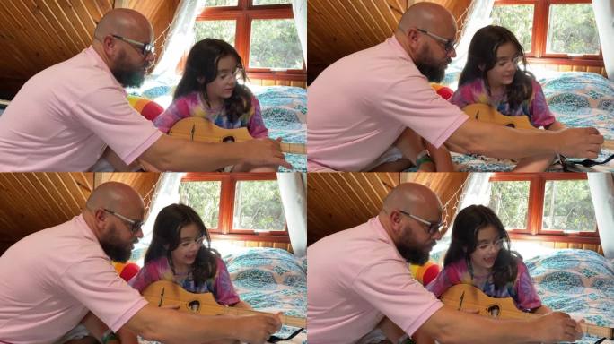 女儿和父亲学习弹吉他