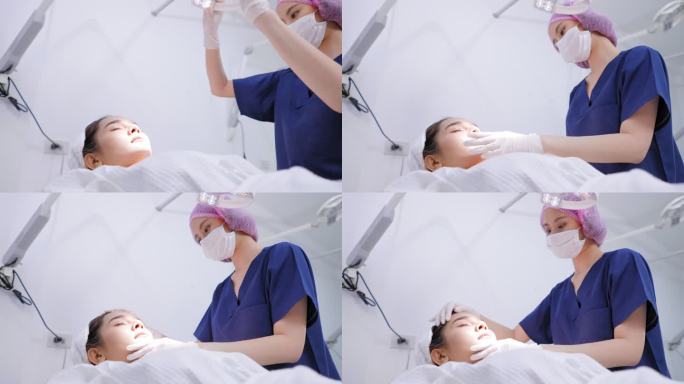 侧视图：一位医生戴着卫生手套，戴着发帽，为年轻的亚洲女性提供医疗服务，将手术灯调整到面部，检查皮肤质
