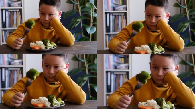 孩子对不得不吃蔬菜很不高兴。他的盘子里有很多蔬菜。他讨厌蔬菜。