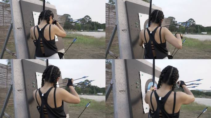 特写在靶场练习射箭的迷人亚洲女性，她很高兴自己击中了目标。